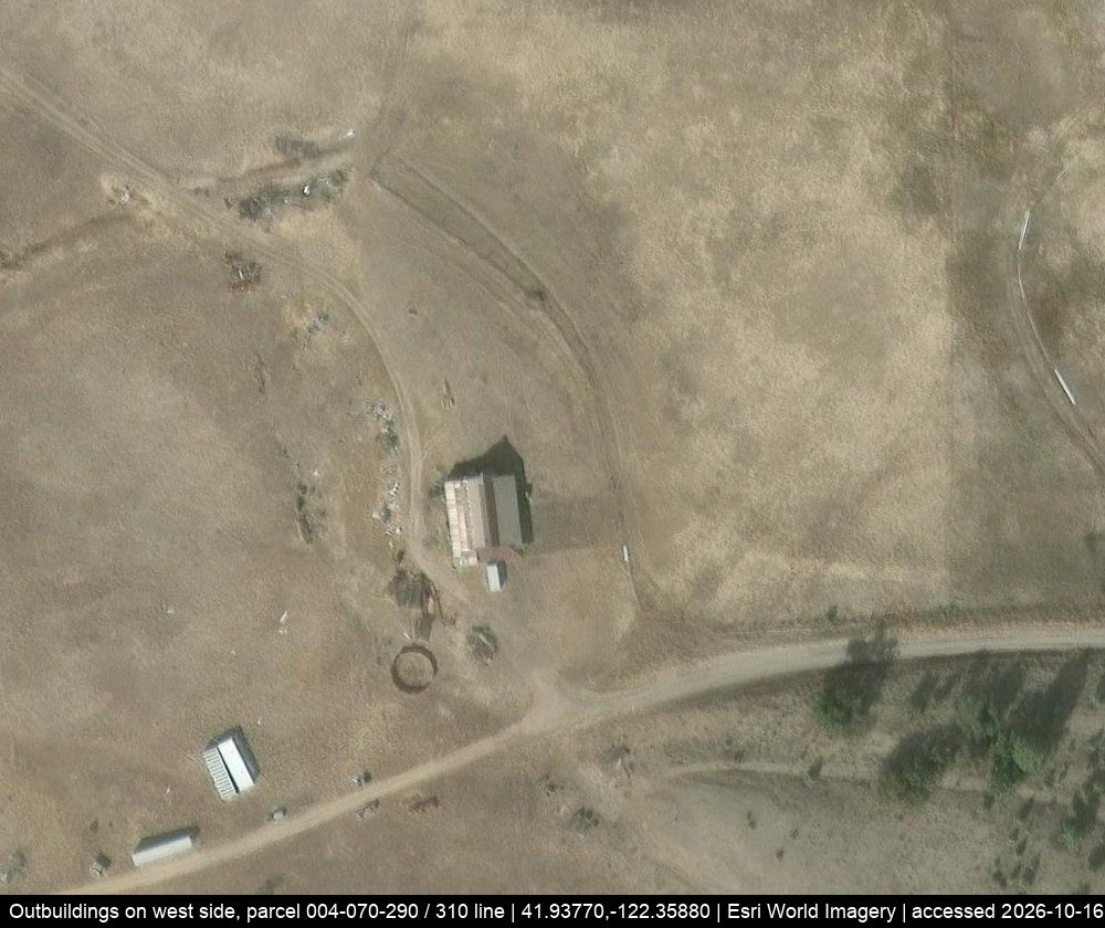 The west ranch yard: a barn, a round pen and long sheds